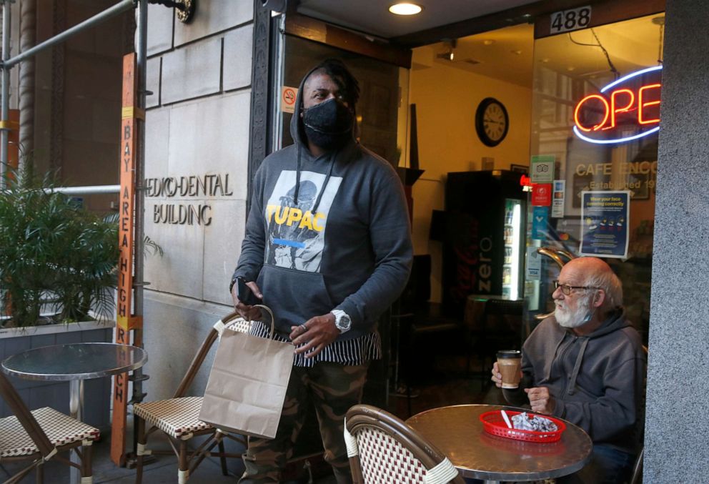 PHOTO: DoorDash driver Gleyson Coelho picks up an order for delivery at Cafe Encore on Post Street in San Francisco, Nov. 4, 2020.