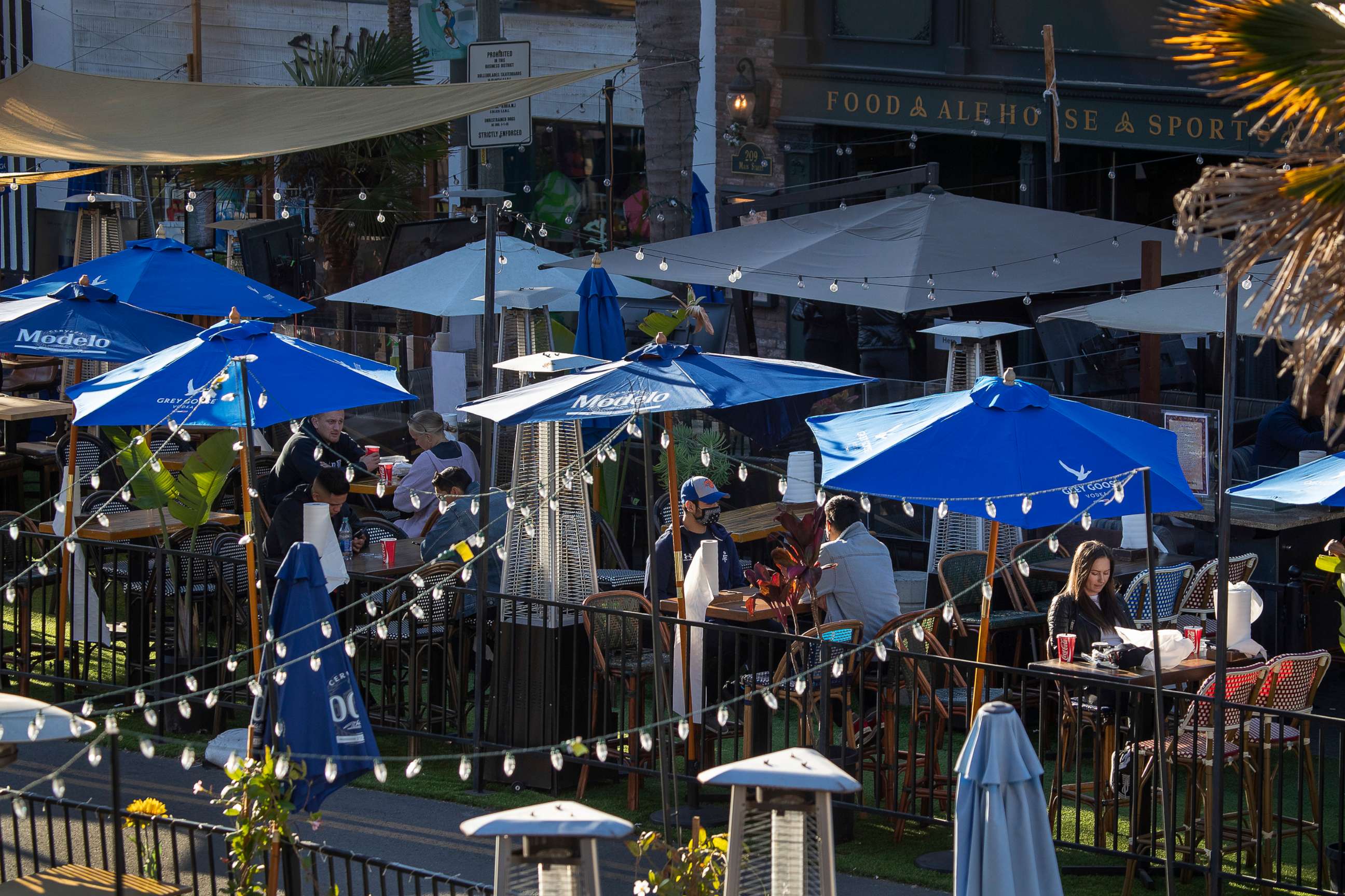 PHOTO: People dine outdoors at restaurants on Main Street in Huntington Beach, Calif., Jan, 26, 2021.