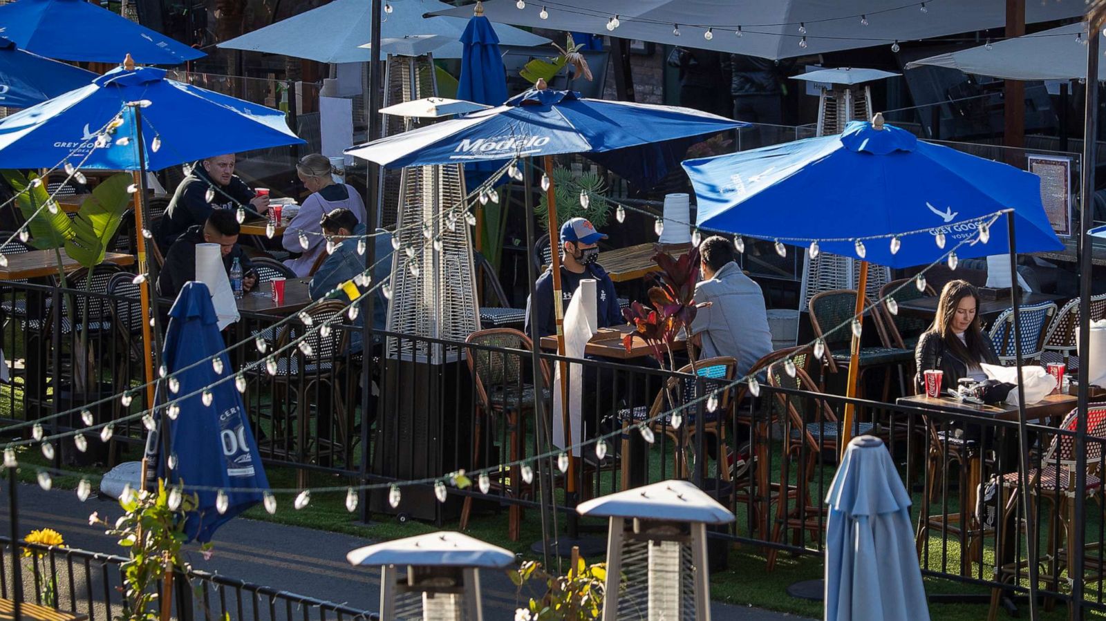 PHOTO: People dine outdoors at restaurants on Main Street in Huntington Beach, Calif., Jan, 26, 2021.