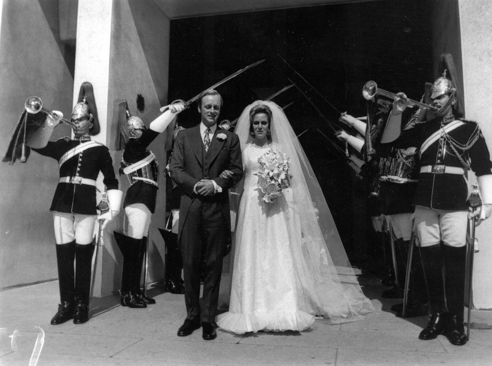 PHOTO: In this July 4, 1973, file photo, Andrew and Camilla Parker-Bowles pose after their wedding at the Guard's Chapel, London, with members of the Horseguards present.