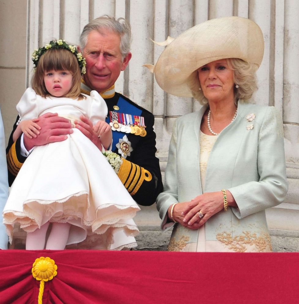 PHOTO: Prince Charles, Prince of Wales holds Eliza Lopes as he and Camilla, Duchess of Cornwall greet crowd of admirers from the balcony of Buckingham Palace on April 29, 2011.