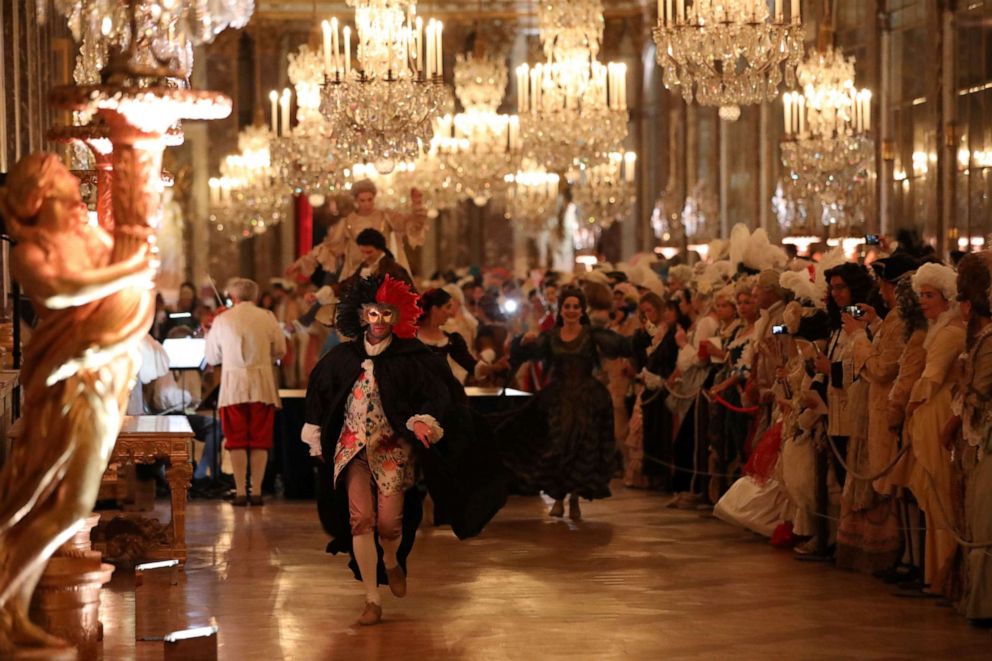 PHOTO: People dressed in period costumes take part in the "Fetes Galantes" fancy dress evening in the "Galerie des Glaces" (Hall of Mirrors) at the Chateau de Versailles in Versailles, west of Paris, on May 28, 2018.