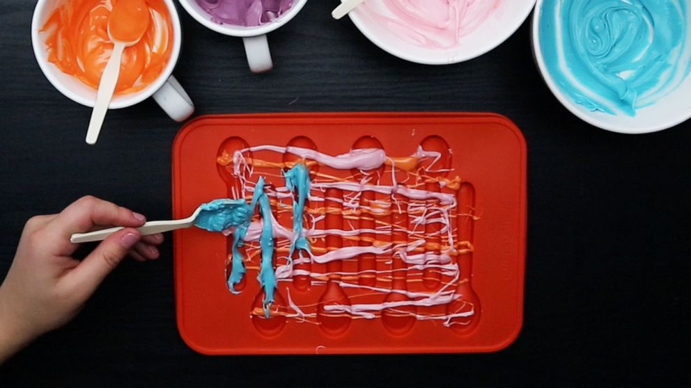 PHOTO: Drizzling melted candy into silicon spoon mold.