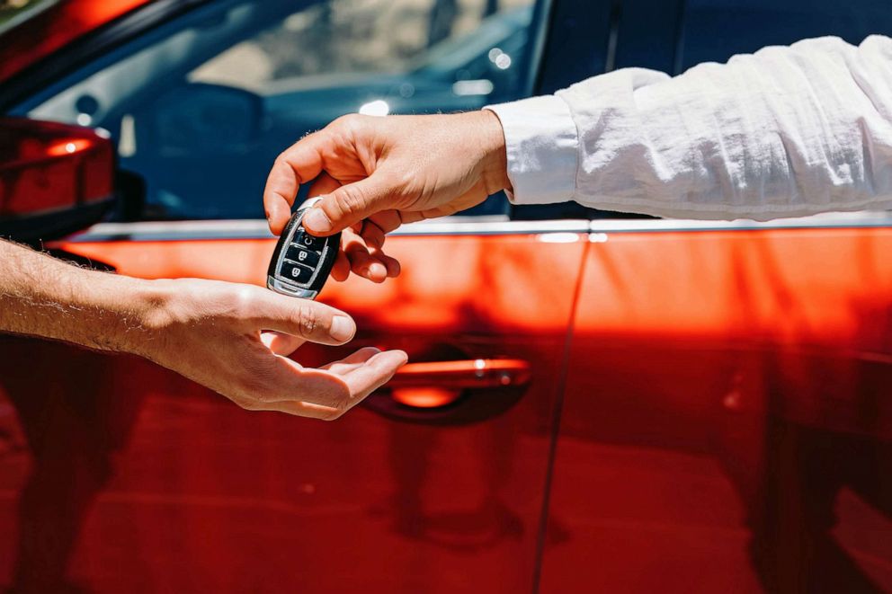STOCK PHOTO: Dealer Giving Car Keys To The New Owner