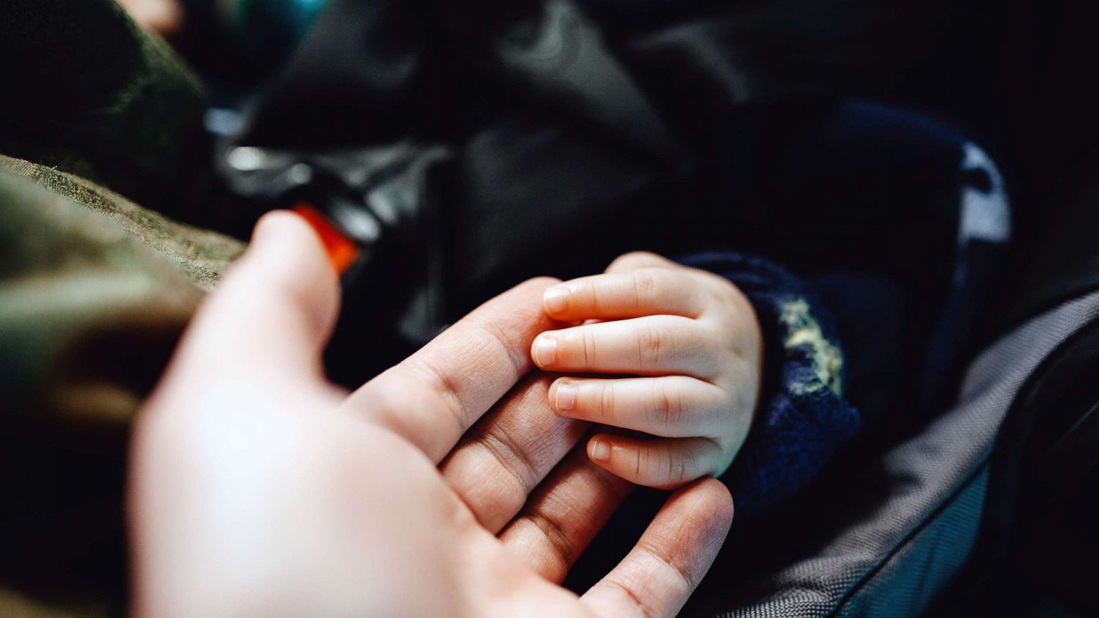 PHOTO: A man holds a baby's hand gently in this undated stock photo.