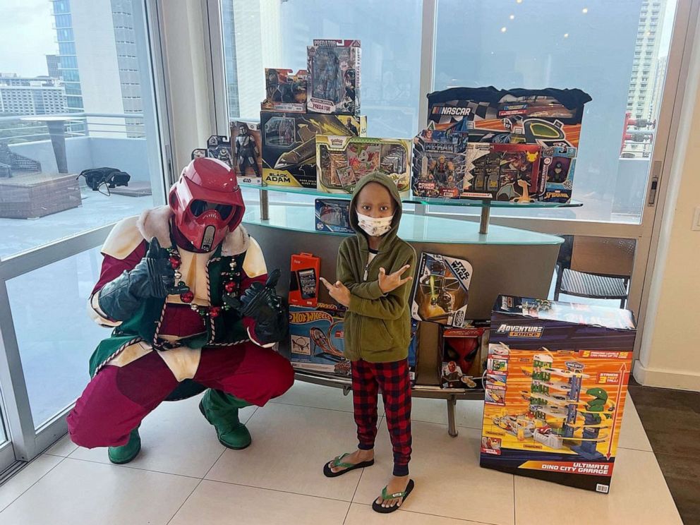 PHOTOS: Jaysden posed for a picture with Williams on Monday with multiple Christmas presents that surprised him.