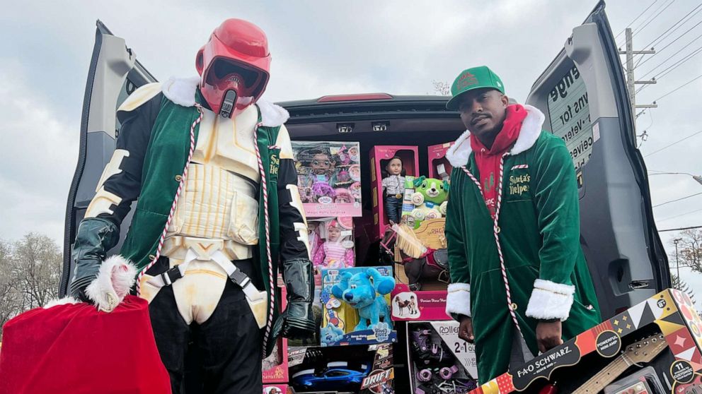 Photo: Yuri Williams and Rodney Smith Jr. dress up as superheroes and elves to surprise people and animals in need, offering gifts, donations and much-needed support.
