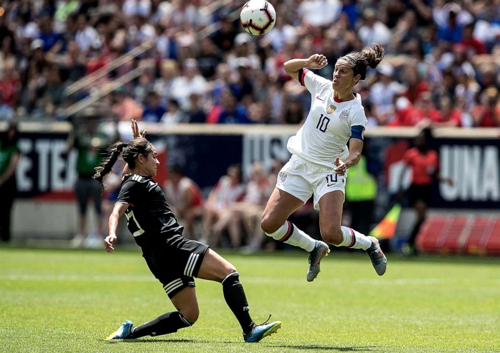 PHOTO: U.S. midfielder Carli Lloyd plays the ball against Mexico defender during the second half of a Countdown to the Cup Women's Soccer match in Harrison, N.J.