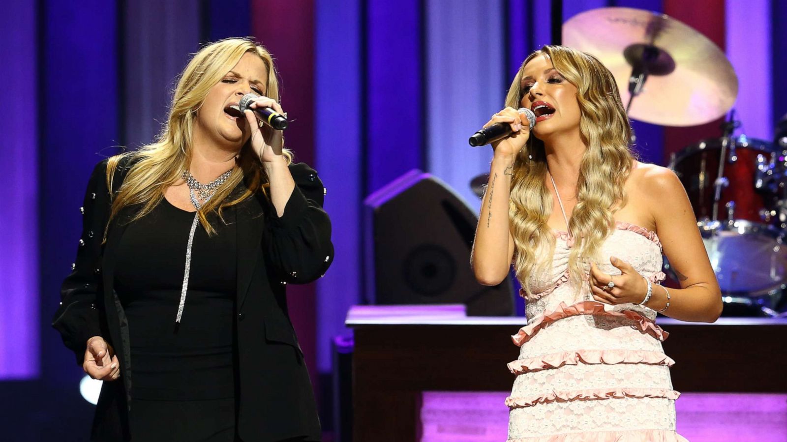 PHOTO: Singer-songwriter Carly Pearce, right, is joined on stage by Trisha Yearwood during her Induction to the Grand Ole Opry at Grand Ole Opry House on Aug. 03, 2021, in Nashville, Tenn.