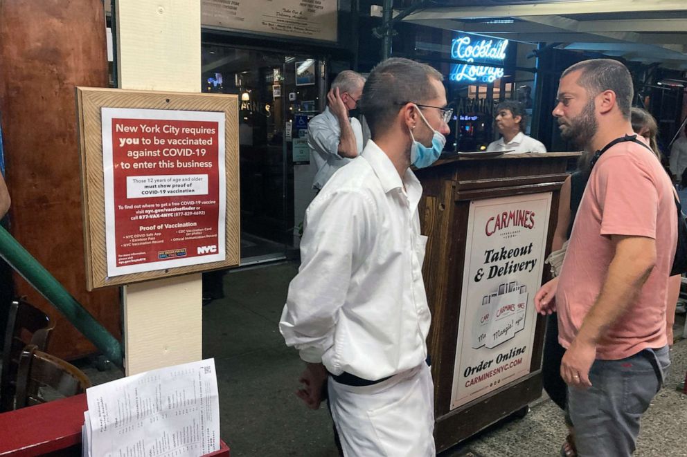PHOTO: A sign informs customers they must show proof of vaccination against COVID-19 to dine indoors at Carmine's Italian restaurant on the Upper West Side of Manhattan in New York, Aug. 31, 2021.