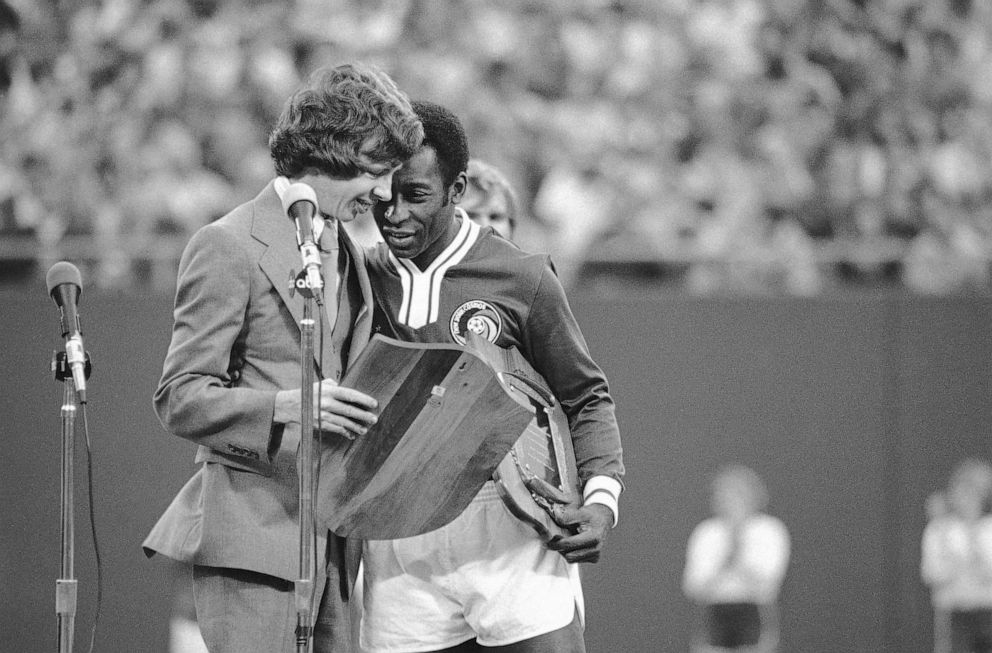 PHOTO: Jeff Carter, son of President Jimmy Carter, gives Pele a plaque thanking Pele for his contributions while playing for the New York Cosmos during ceremonies before Pele's last game, Oct. 1, 1977 at Giant Stadium in East Rutherford, N.J.