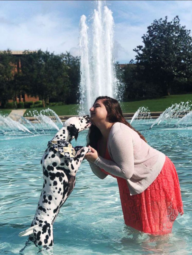 PHOTO: Casey Bruno received a Bachelor's degree from the University of Central Florida and her service dog, Paisley, stood by for moral support.