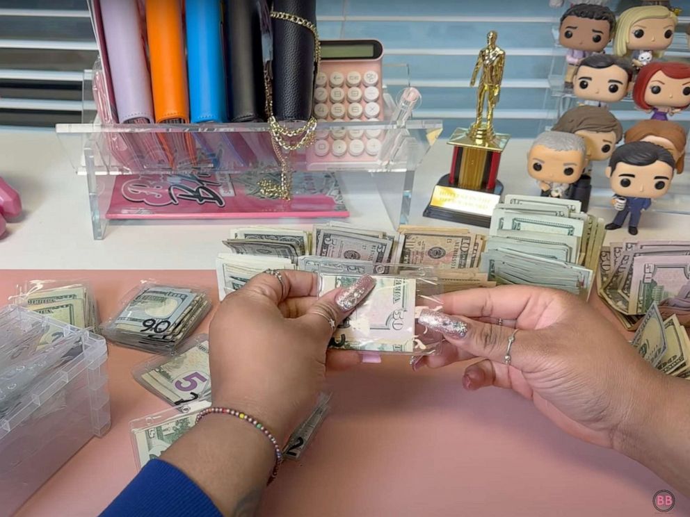 PHOTO: Jazmine Taylor uses the cash-stuffing method in this video screen grab to budget.