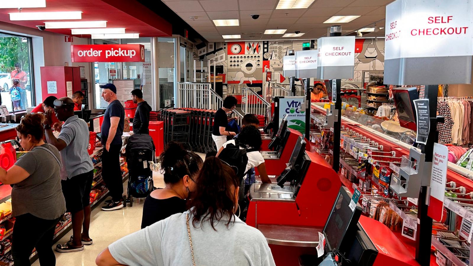 PHOTO: In this Aug. 13, 2023 file photo, customers are seen using the self-checkout kiosks at a Target store in Queens, N.Y.