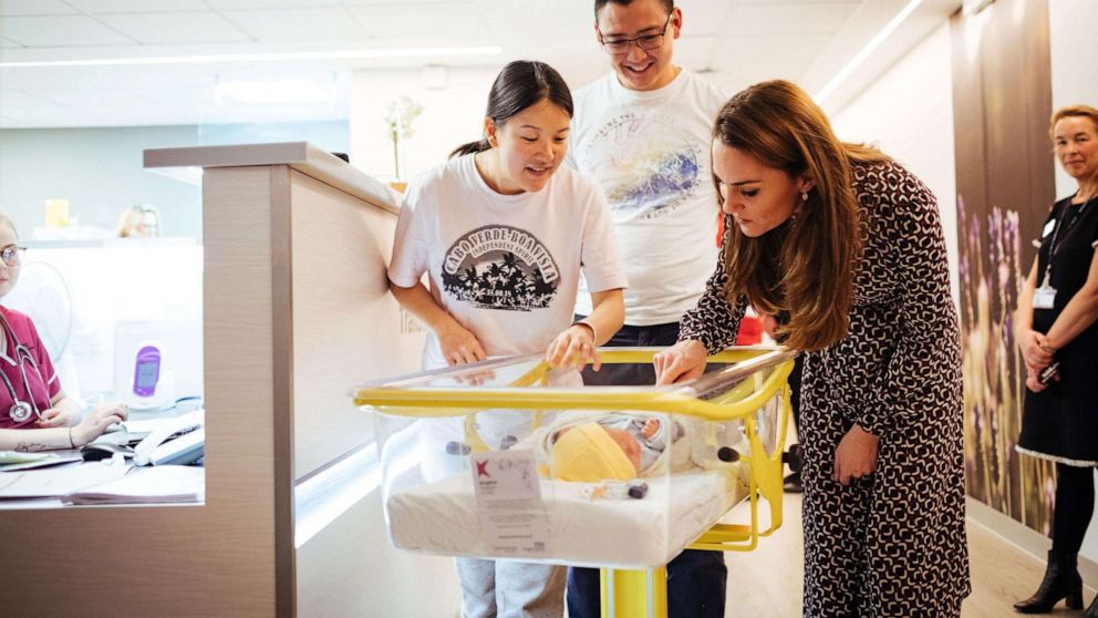 PHOTO: Britain's Catherine, Duchess of Cambridge, looks at a baby with its parents at Kingston Hospital Maternity Unit, in Kingston Upon Thames, Greater London, Britain in this handout taken sometime November, 2019 and released Dec. 27, 2019.