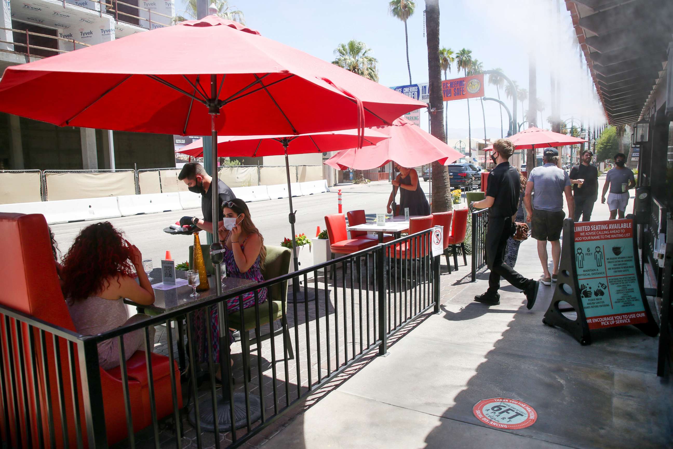 PHOTO: Customers dine in a socially distanced patio space in front of Tac/Quila restaurant in Palm Springs, Calif., Aug. 11, 2020. 