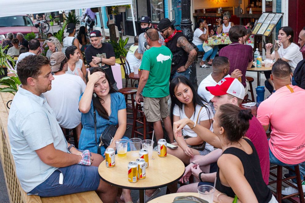 PHOTO: Unmasked and not socially distanced customers use outdoor seating in the Brooklyn borough of New York, July 17, 2020.