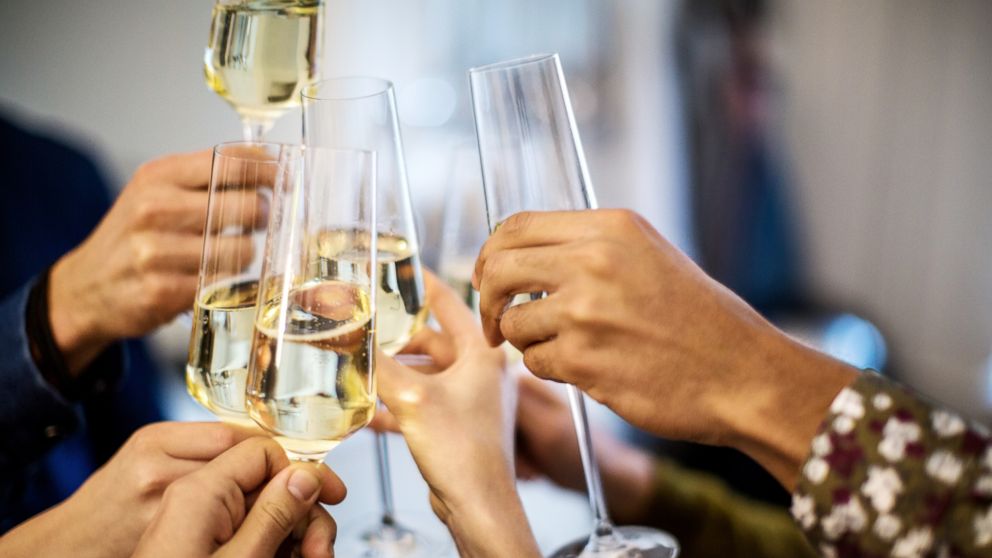 People toast champagne flutes in this undated stock photo.