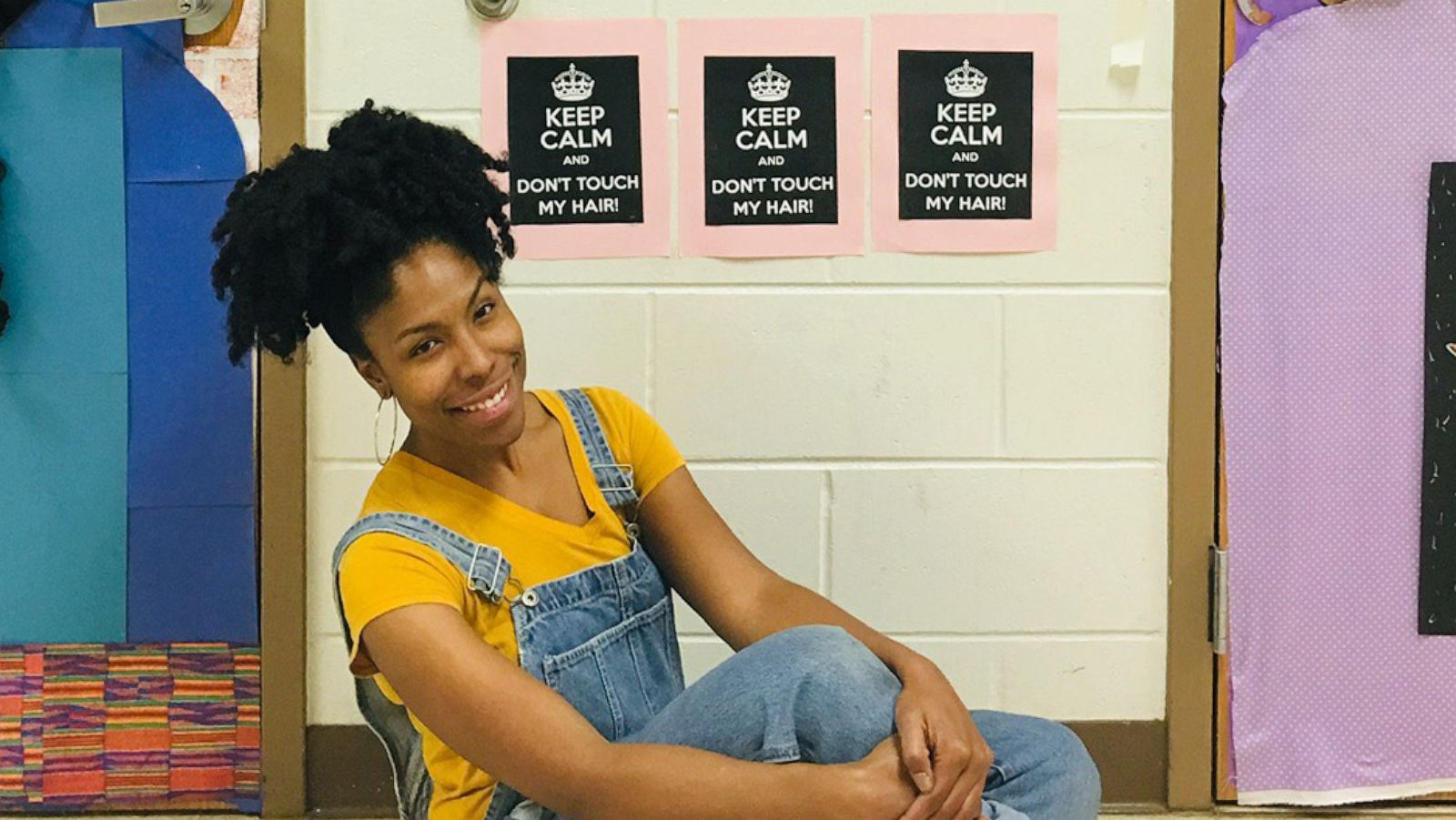 PHOTO: Teacher Chanique Davis, poses in front of her decorated doors that honor Black History Month in Fla.