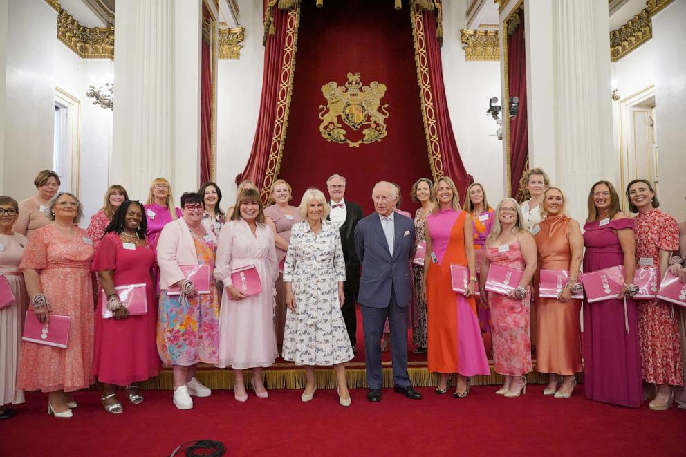 PHOTO: King Charles and Queen Camilla pose for a photo with Lorraine Kelly and members of the Change + Check Choir during a reception in Buckingham Palace, London, April 30, 2025.