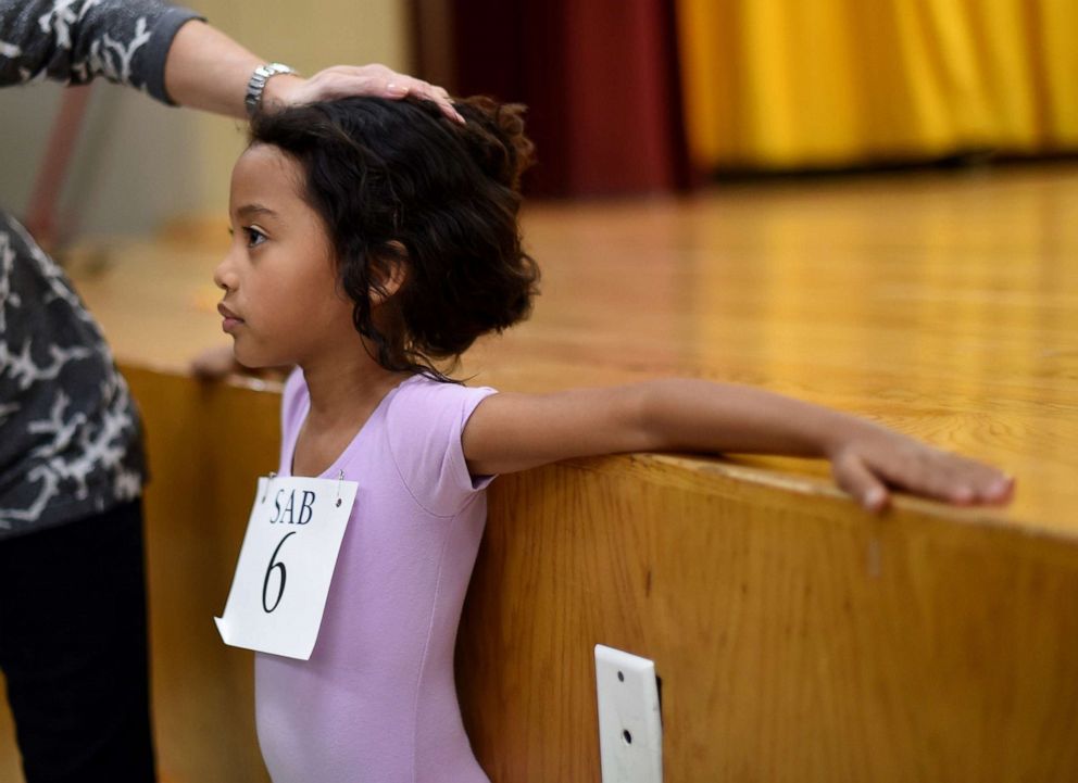 PHOTO: Six-year-old ballet dancer Charlotte Nebres prepares for auditioning as boys and girls ages 6 to 7 try out for The School of American Ballet Winter Term at the P.S. 124 Yung Wing school in New York, April 16, 2015.