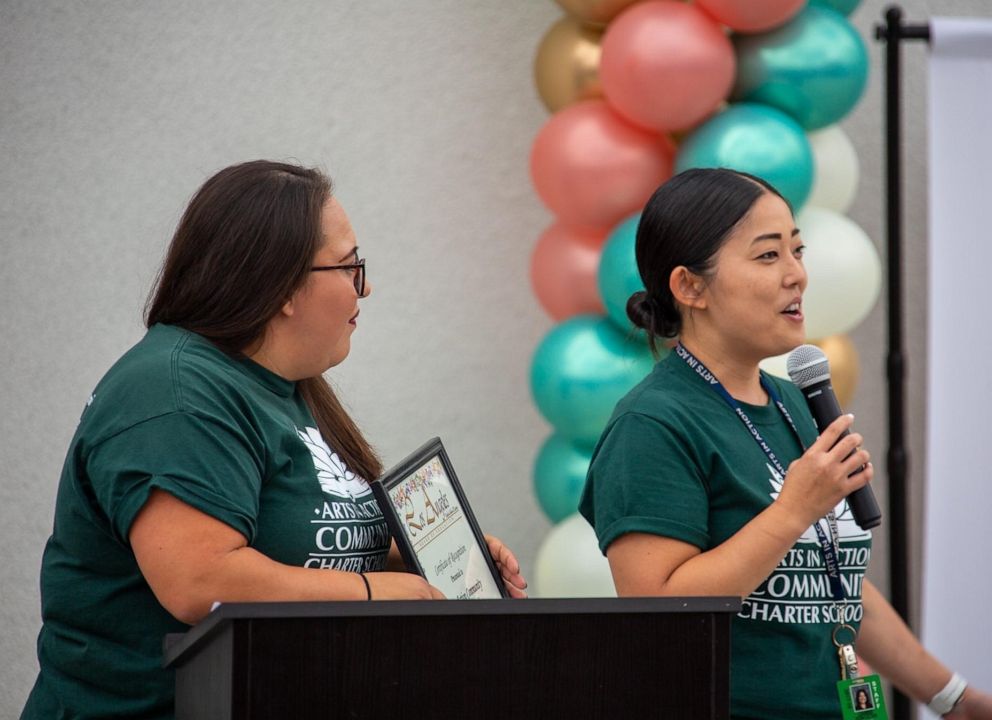 PHOTO: Stephanie Conde holds a certificate of recognition for the Arts in Action Community Charter Schools in East Los Angeles before the pandemic.