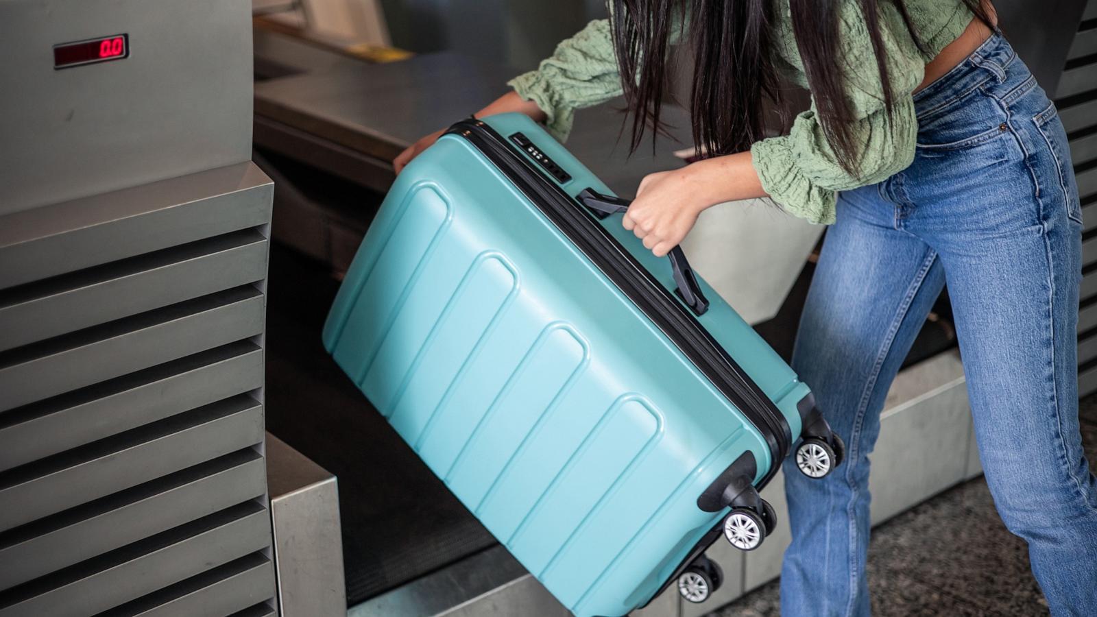 PHOTO: In this undated stock photo, a woman is seen dropping off her luggage at the check-in counter of an airport.