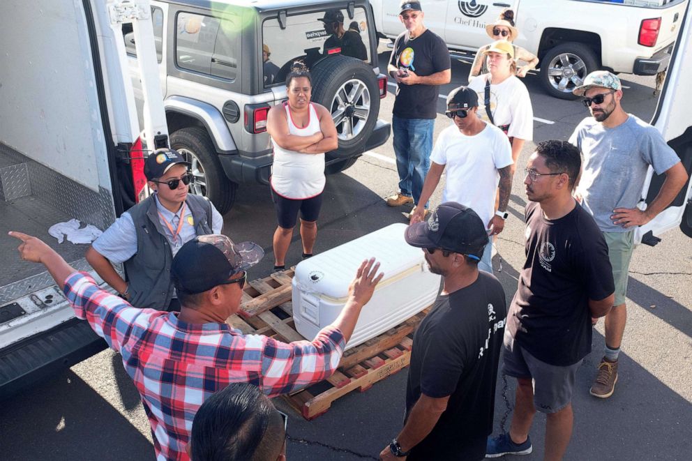 PHOTO: Chef Isaac Bancaco, left in plaid shirt, Executive Chef at Pacifico in Lahaina which was destroyed in the fire, directs the Chef Hui volunteers helping supply meals to wildfire victims in Lahaina, Maui, Aug. 12 2023.