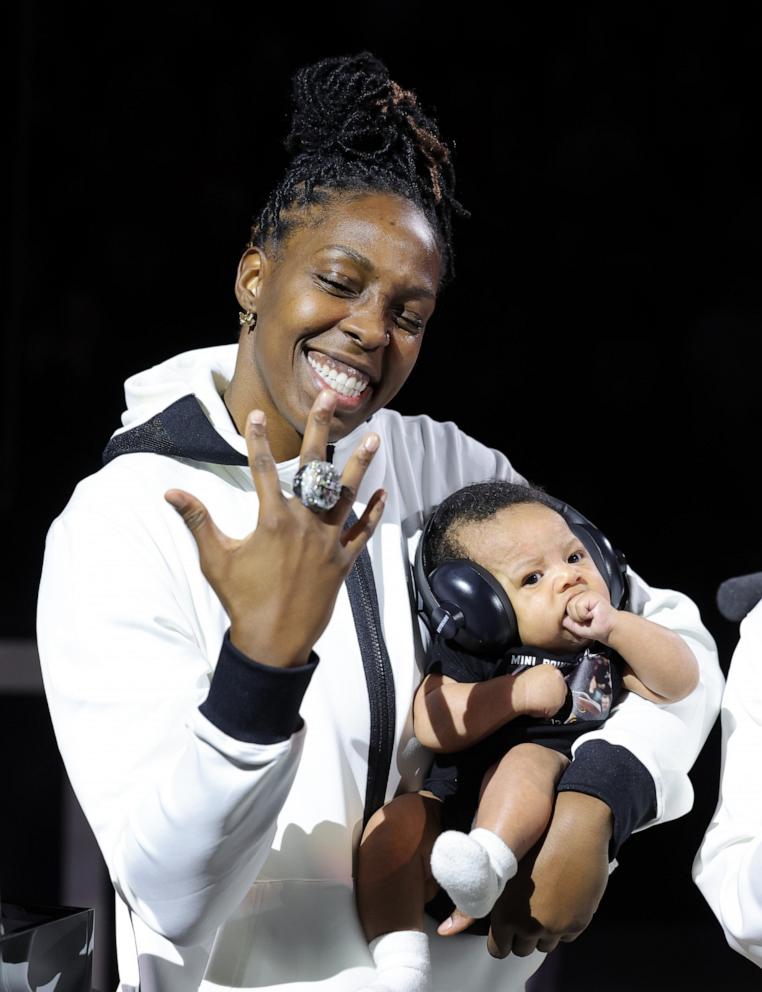 PHOTO: Chelsea Gray of the Las Vegas Aces holds Lennox Gray as she receives her 2023 WNBA championship ring before the team's home opener against the Phoenix Mercury, May 14, 2024, in Las Vegas.