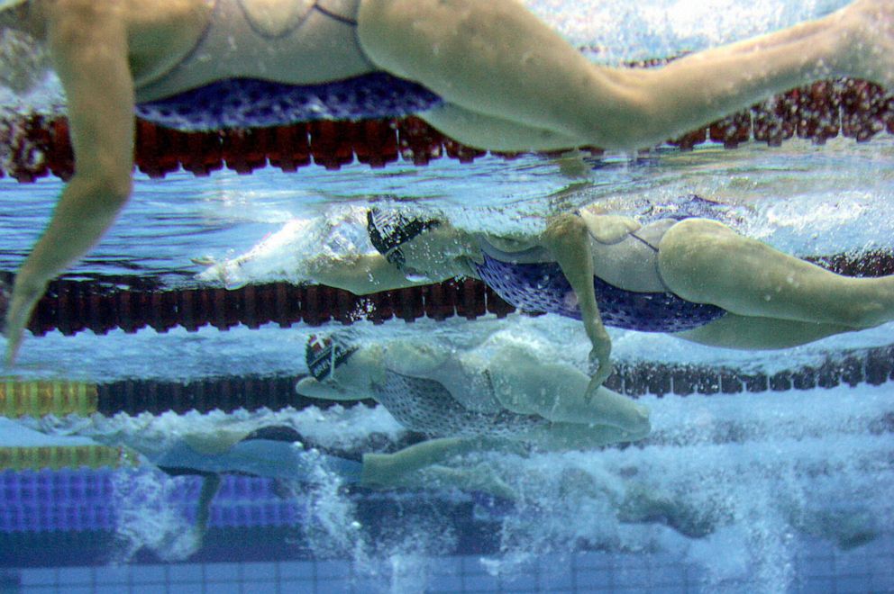 PHOTO: Cheryl Angelelli, second from top, vies in the women's 100 meters freestyle - S4 during the 12th Paralympic Games at the Olympic Aquatic Centre in Athens, Sept. 14, 2004.