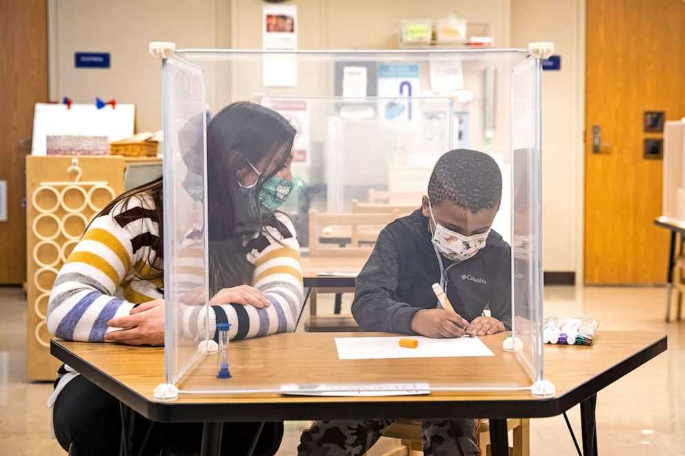 PHOTO: Pre-kindergarten teacher Sarah McCarthy works with a student at Dawes Elementary in Chicago, Jan. 11, 2021. Chicago Public Schools students began their return to the classroom after going remote last March due to the coronavirus pandemic.