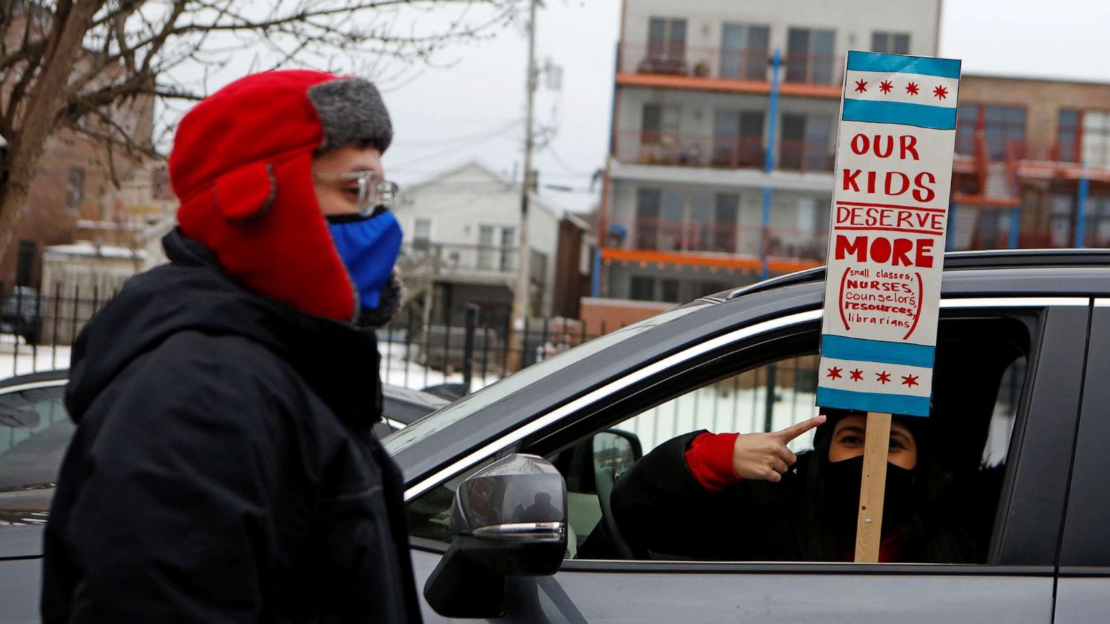 PHOTO: English Language Program teacher Marlon Henriquez and bilingual teacher Daniela Lugo prepare for a car caravan protest as union negotiations with Chicago Public Schools continue over a COVID-19 safety plan agreement in Chicago, Jan. 30, 2021.