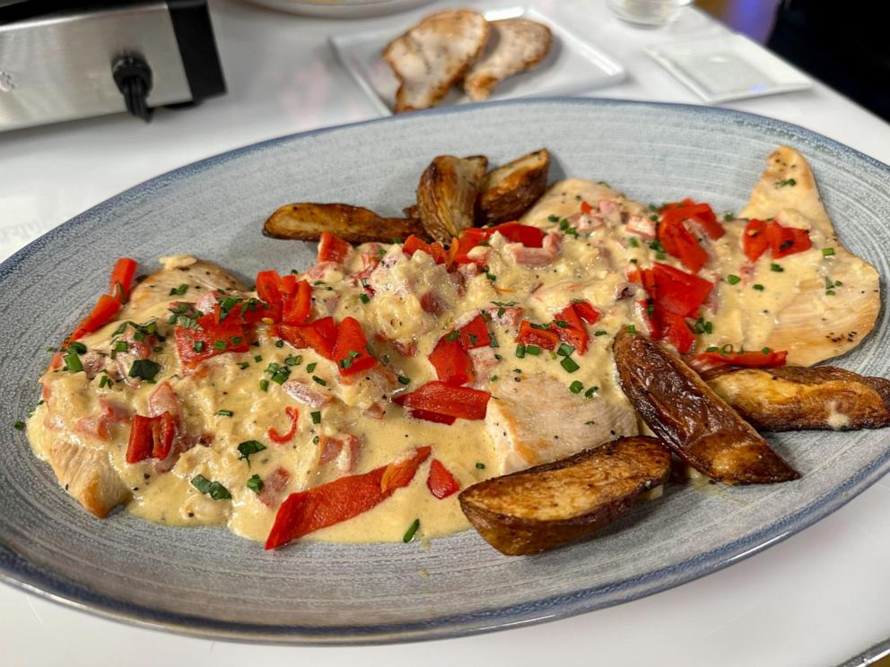 PHOTO: A plate of creamy red pepper topped chicken breast.