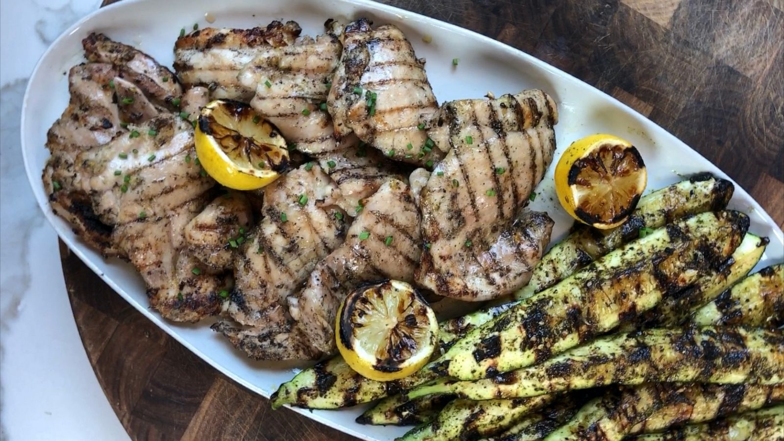 PHOTO: Grilled chicken and zucchini with za'atar spice and charred lemons.