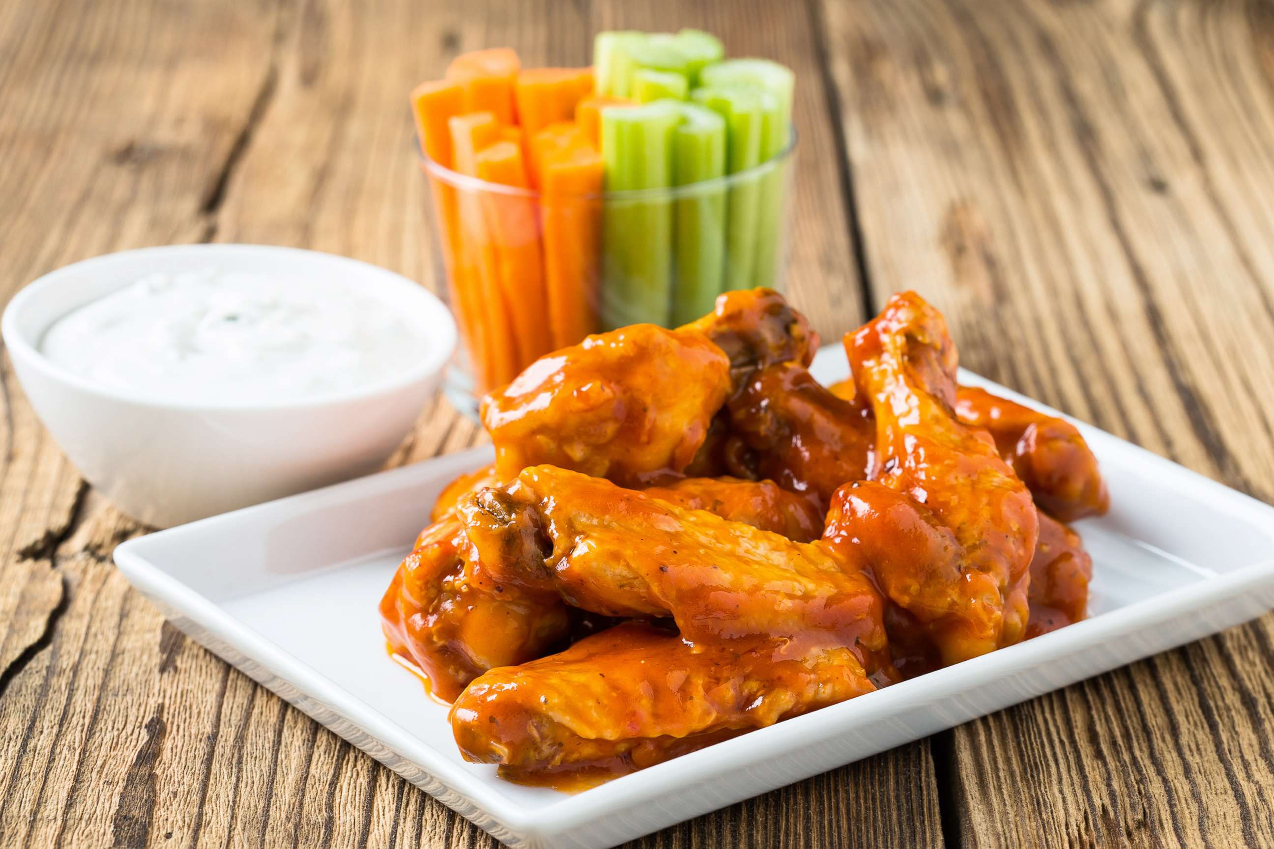 PHOTO: Buffalo chicken wings are served with celery sticks, carrot sticks and blue cheese dressing for dipping in a stock image.