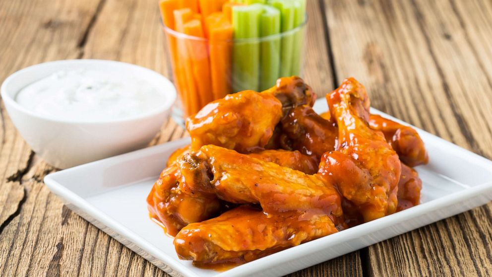 PHOTO: Buffalo chicken wings are served with celery sticks, carrot sticks and blue cheese dressing for dipping in a stock image.