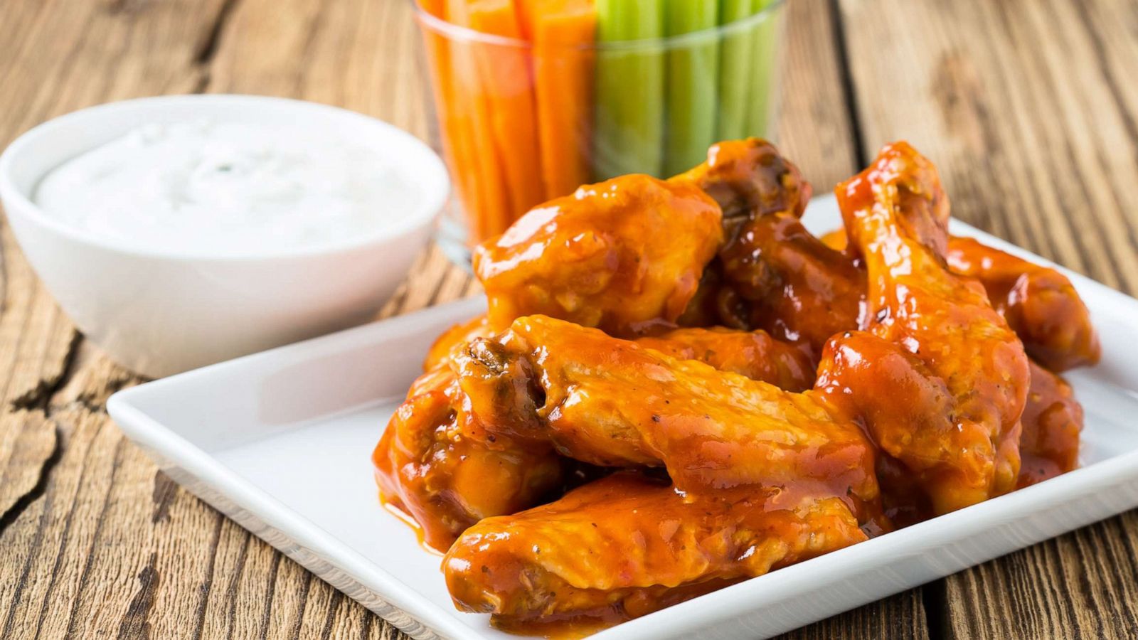 PHOTO: Buffalo chicken wings are served with celery sticks, carrot sticks and blue cheese dressing for dipping in a stock image.