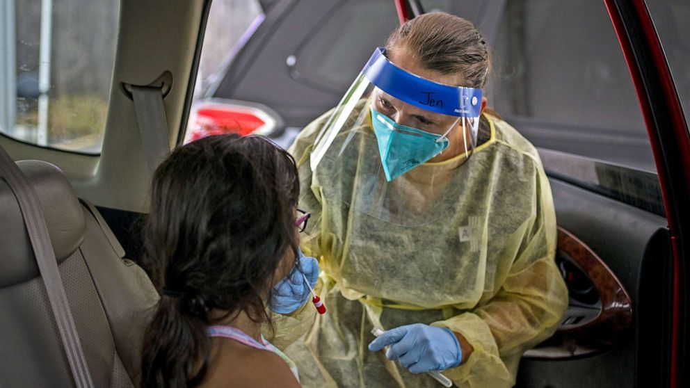 PHOTO: A healthcare worker administers a Covid-19 test to a child at a drive-thru vaccination and testing site in Austin, Texas, Aug. 5, 2021.