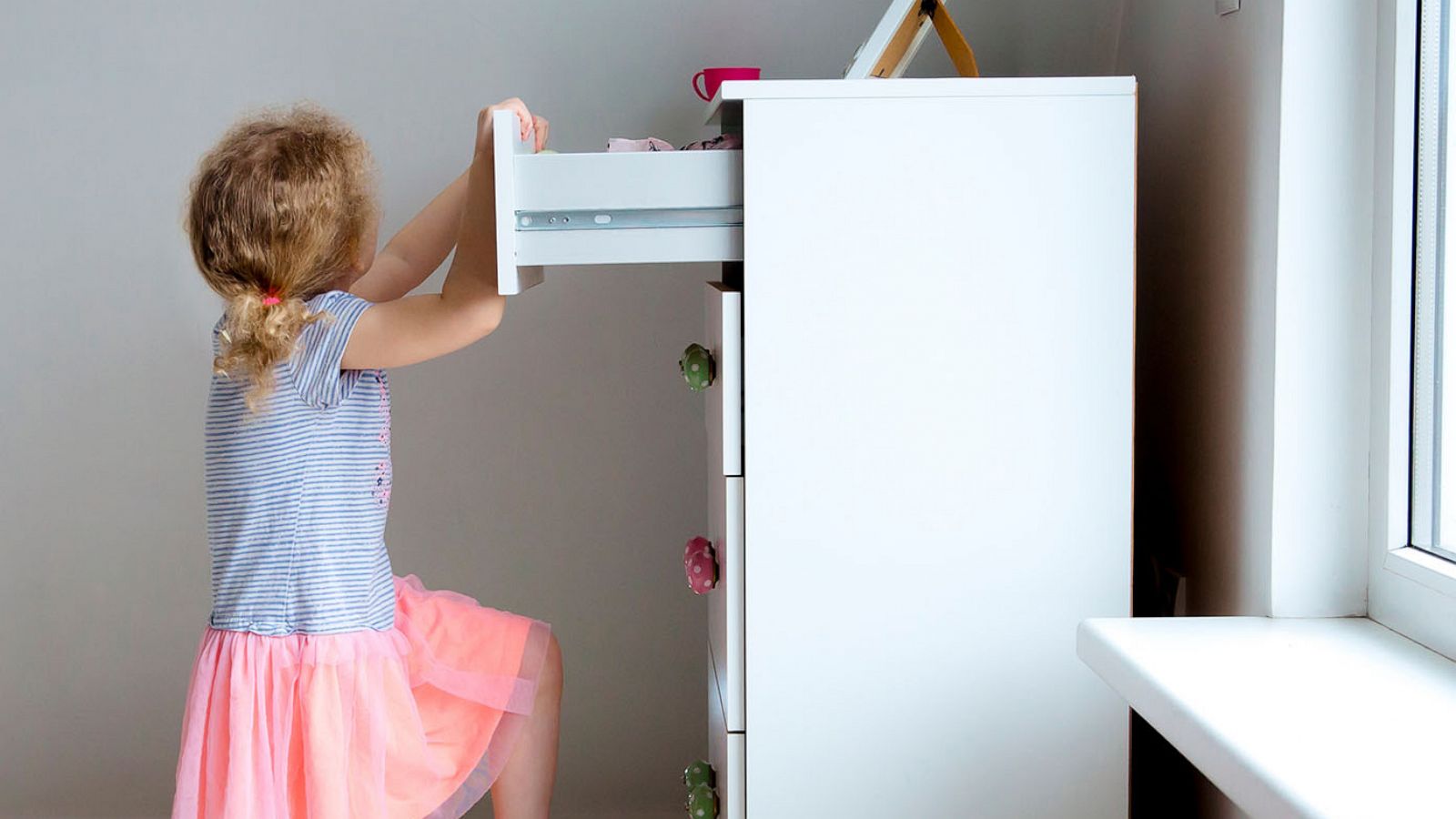 PHOTO: A young child climbs on modern high dresser furniture in an undated stock image.