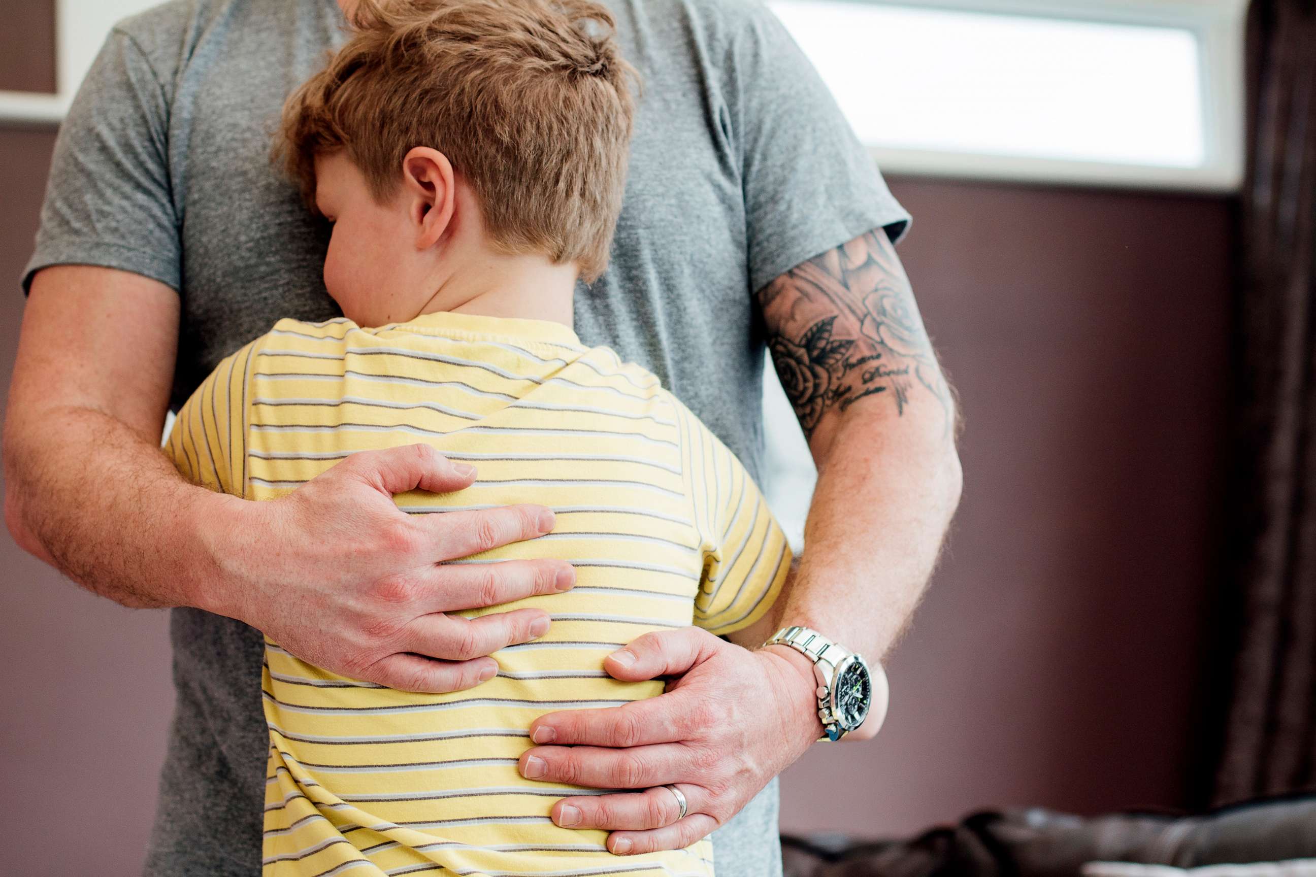 PHOTO: A little boy is hugging his father.