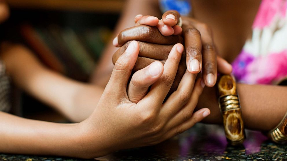 PHOTO: A child and parent holding hands