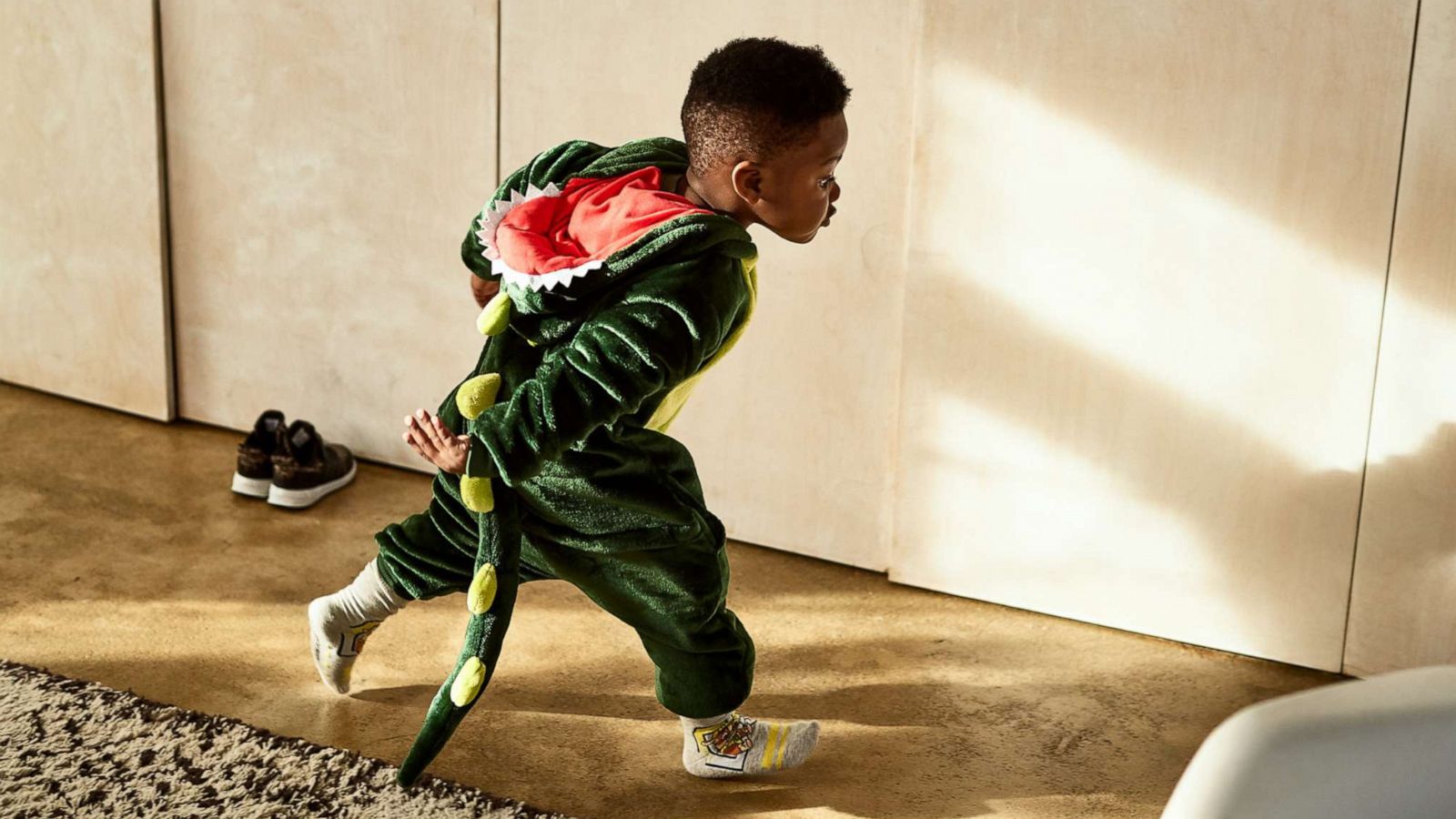 PHOTO: Boy playing in a dragon outfit.