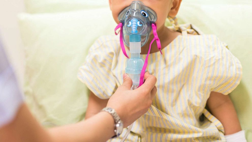 Photo: Stock photo of a nurse giving inhalation therapy to a pediatric patient. 