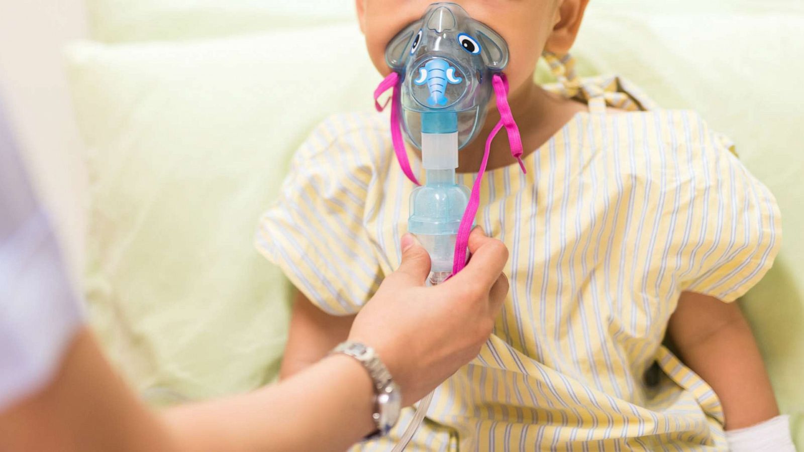 PHOTO: A nurse administers inhalation therapy to a pediatric patient in a stock photo.