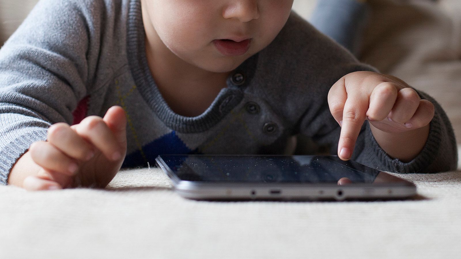 PHOTO: A child looks at a tablet.