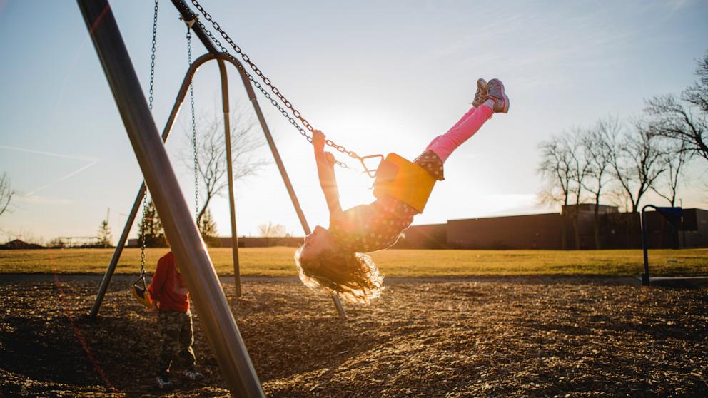 PHOTO: Stock photo of children on a swing.