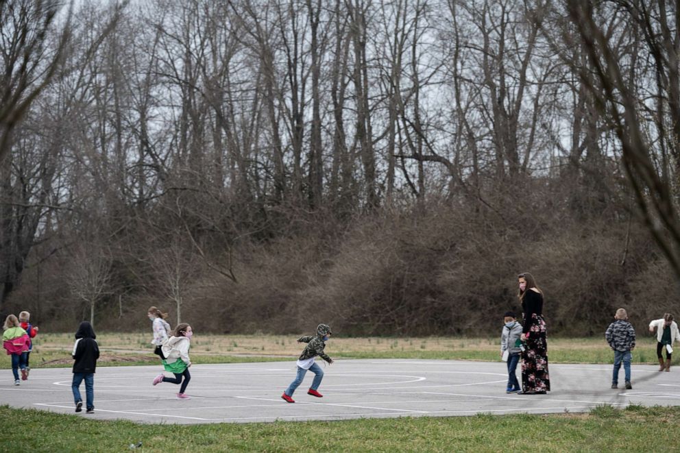 PHOTO: Students run and play during socially distanced recess on the playground of Medora Elementary School on March 17, 2021, in Louisville, Ky.