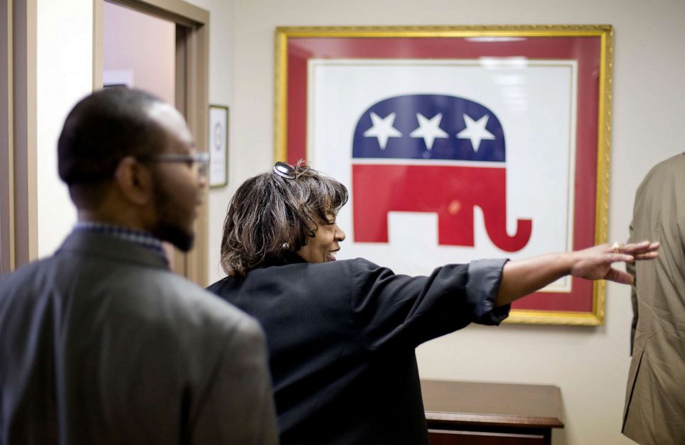 PHOTO: This photo taken May 19, 2014, shows former Republican candidate for Congress, Vivian Childs, right, walking through the Georgia GOP headquarters in Atlanta. 
