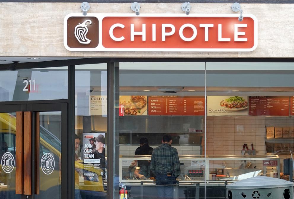 PHOTO: A customer orders food at a Chipotle restaurant on April 26, 2022 in San Francisco.