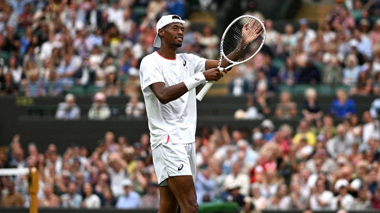 PHOTO: Christopher Eubanks applauds a fan catching a ball against Daniil Medvedev in the Men's Singles Quarter Final match during day ten of Wimbledon 2023 at All England Lawn Tennis and Croquet Club, July 12, 2023, in London.